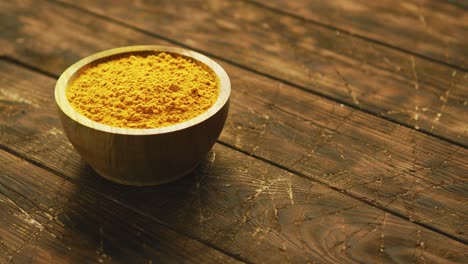 small bowl of orange turmeric spice