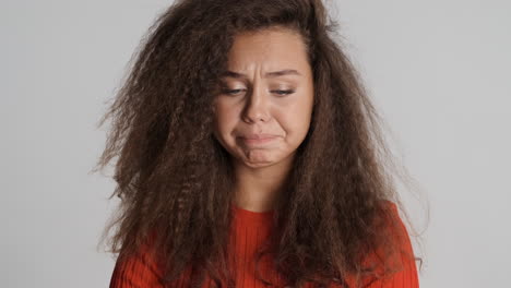 sad caucasian curly haired woman.