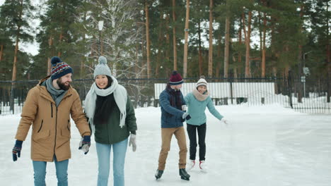 friends ice skating in winter park