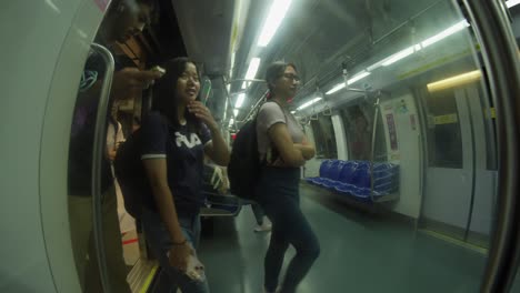 passengers getting on mrt train in singapore. fish-eye view, slow motion