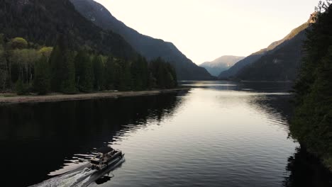 Aerial-view-of-boat-floating-along-Indian-Arm,-an-inlet-ocean-in-British-Columbia,-Canada