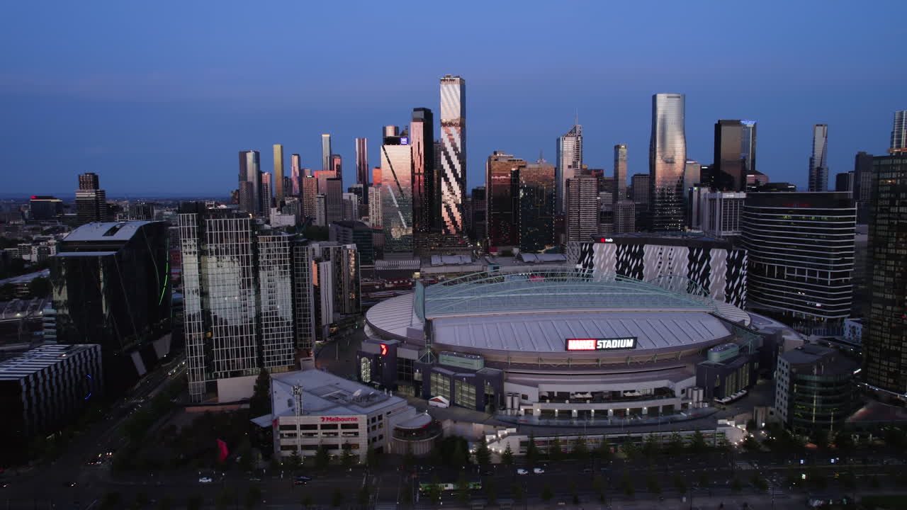 Aerial tracking shot in front of Marvel stadium and skyscrapers of Melbourne