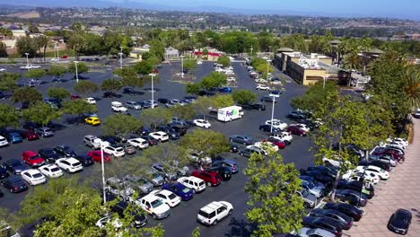 aerial fly through of a shopping mall strip mall parking lot shot1