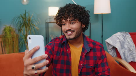 Indian-man-blogger-taking-selfie-on-smartphone-recording-vlog-stories-for-social-media-subscribers