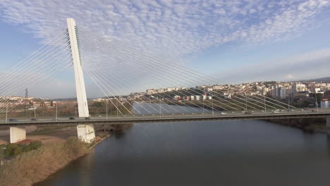 gorgeous view of the rainha santa isabel bridge in coimbra with bright blue sky above - aerial shot