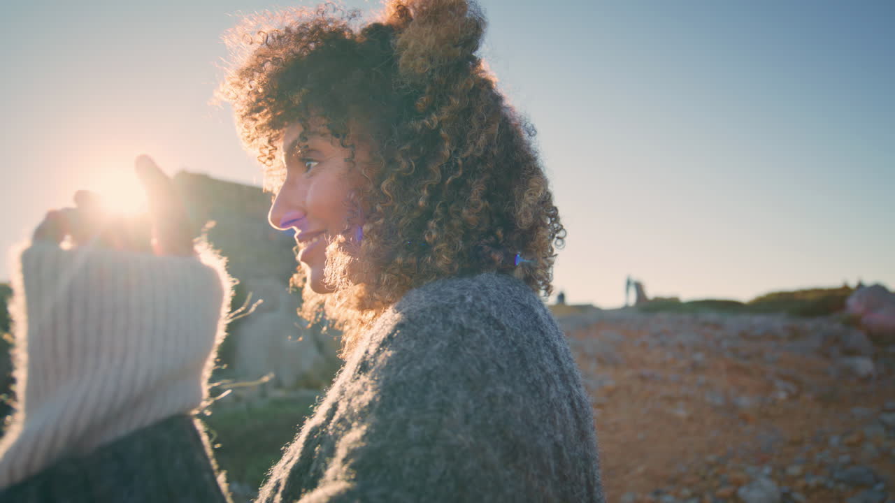 Carefree woman warming sunlight closeup. Brunette lady moving hands smoothly