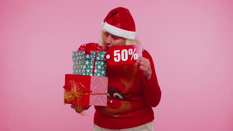 Elderly-woman-in-Christmas-sweater-showing-gift-box-and-50-Percent-discount-inscriptions-banner-text