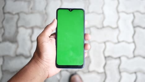 close up of young man hand using smart phone