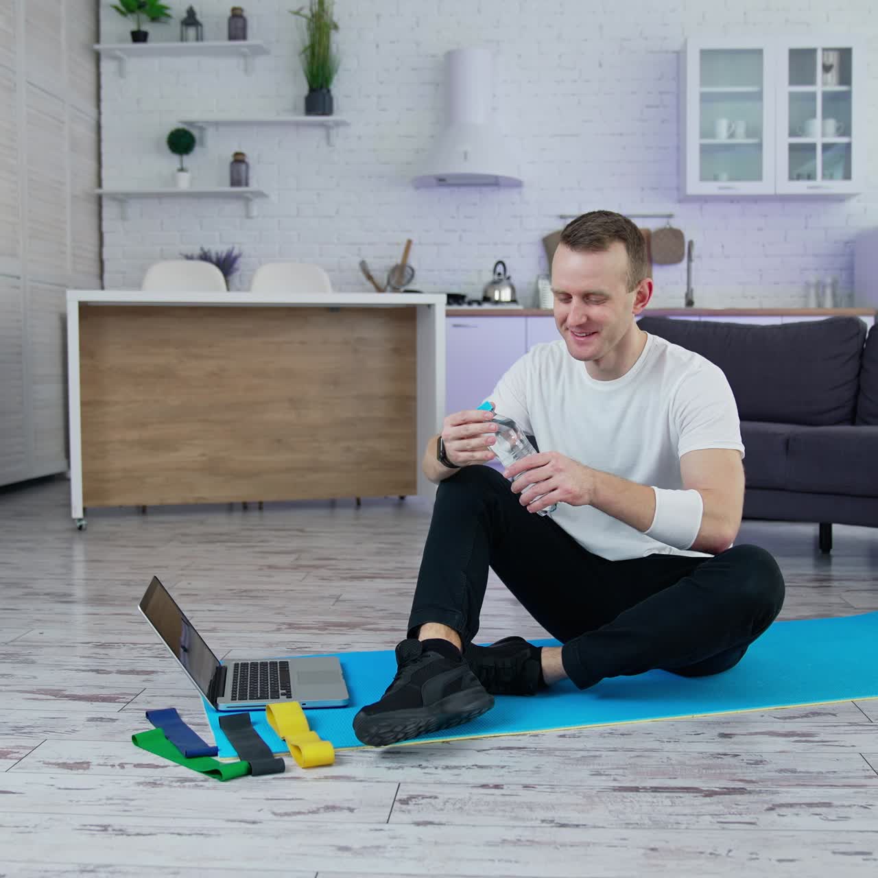 Handsome young sportsman doing exercises on quarantine. Lifestylish athelic active man training indoors