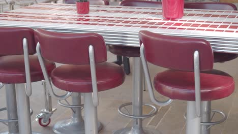 red and silver bar stools at a cafe