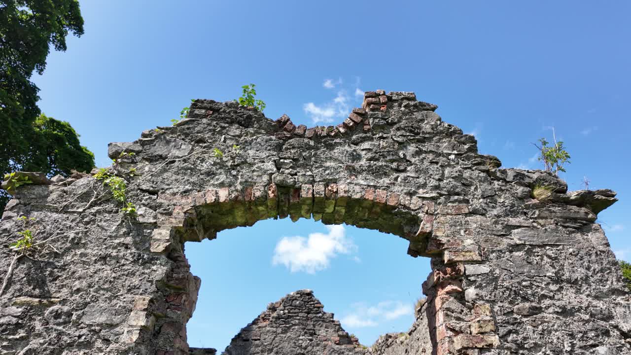 Historic abandoned cottage ruins reclaimed by nature on a sunny day