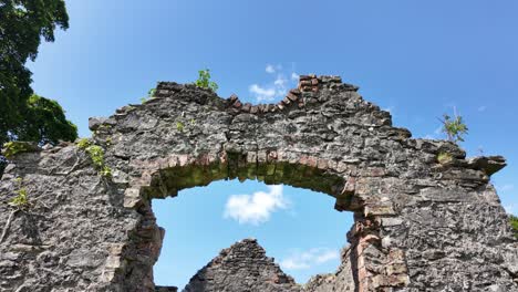 historic abandoned cottage ruins reclaimed by nature on a sunny day