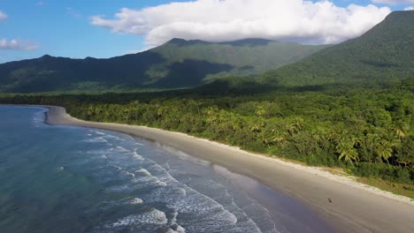 Daintree-Rainforest-and-Cape-Tribulation-aerial-of-beach,-dense-forest-and-cloudy-mountains,-Queensland,-Australia