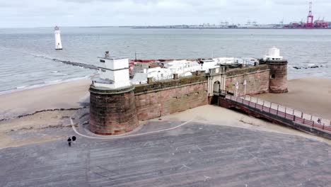 fort perch rock new brighton sandstone coastal defence battery museum and lighthouse aerial view low orbit right