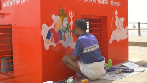 handheld shot of a man painting a wall