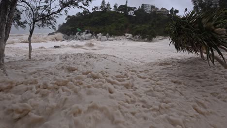cyclone alfred 2025 - sea foam washed up onto the beach during cyclone in gold coast, qld, australia. - closeup shot