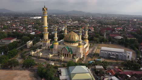 Beautiful-Exterior-Of-Islamic-Center-Mosque-In-Mataram,-Lombok,-Indonesia-With-Colorful-Dome-And-Tall-Minaret---aerial-drone