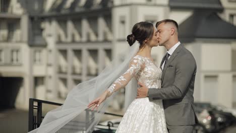 Lovely-newlyweds-caucasian-bride-embracing-groom-making-kiss,-wedding-couple-family-hugging-together