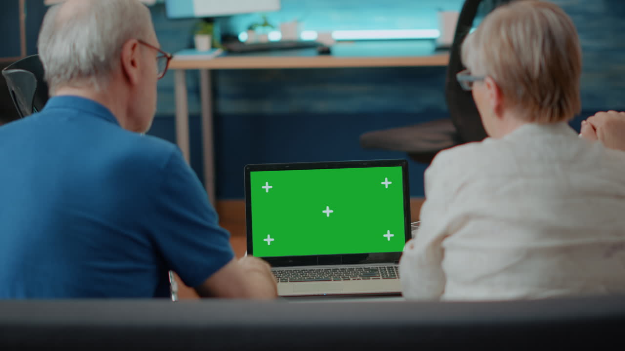 Senior Couple Using Laptop with Green Screen