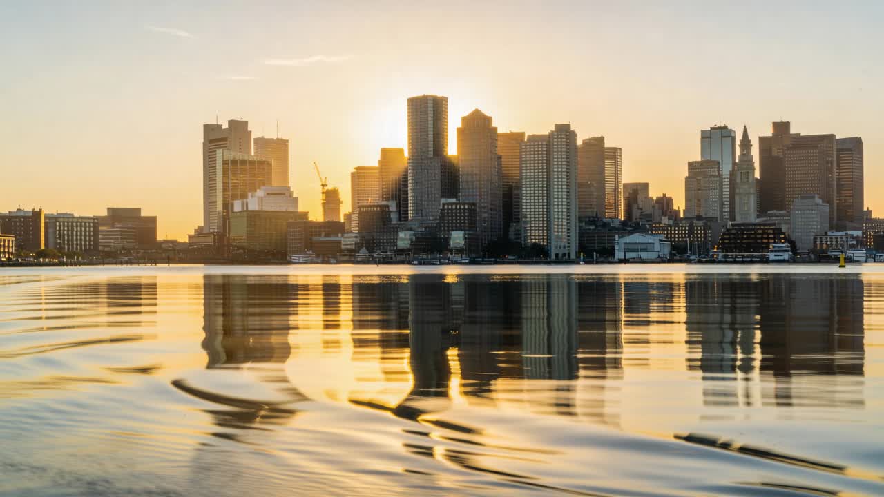 Torres brilhantes no centro da cidade capturando o sol baixo e enviando ondulações de esteira pelo porto, com guindastes e barcos.