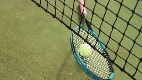 Video-of-tennis-racket-and-tennis-ball-on-the-green-court