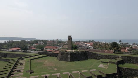 aerial rises over clock tower and medieval fort in galle, sri lanka