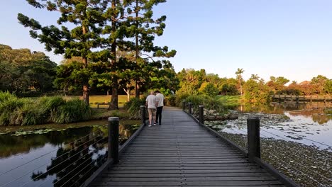 couple walking on a wooden bridge