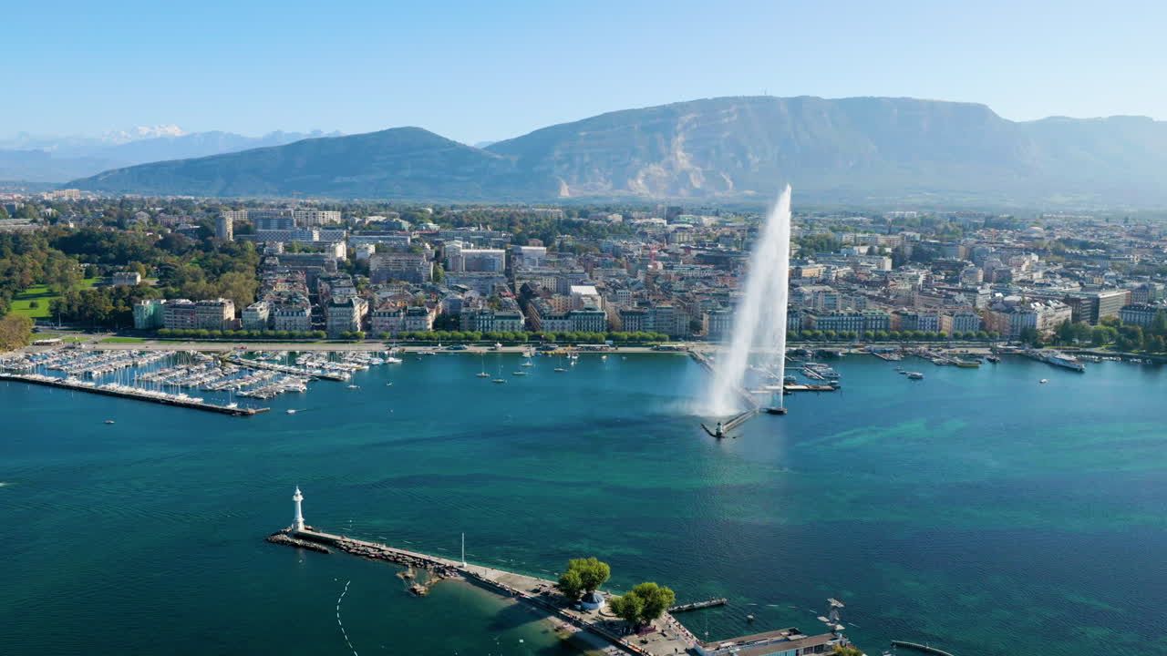 City Harbor Of Geneva With Jet Deau Fountain In Switzerland, Mount Sal&egrave;ve In The Background