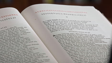 close up of an open book, man's hand flips the pages