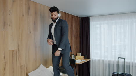 businessman dancing on hotel bed