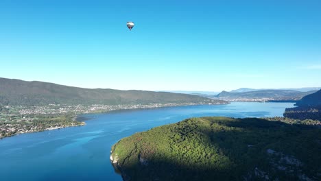 hot air balloons hovering over annecy lake in a summer morning