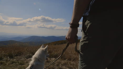 backpacker and his dog at the top of the hill