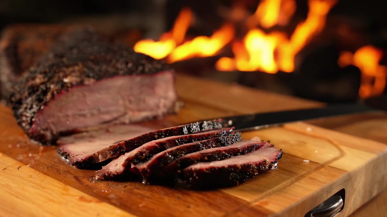 Chef Slicing Smoked Brisket on Wooden Cutting Board