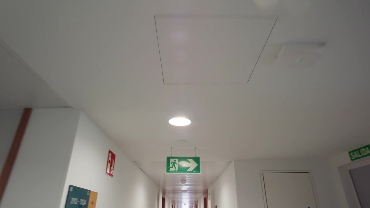 Walking Through a Long, Empty Modern Hotel Hallway