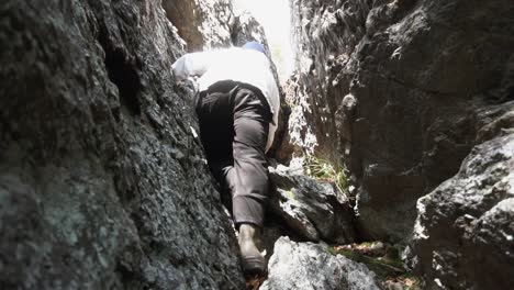 person rock climbing in a mountain gorge