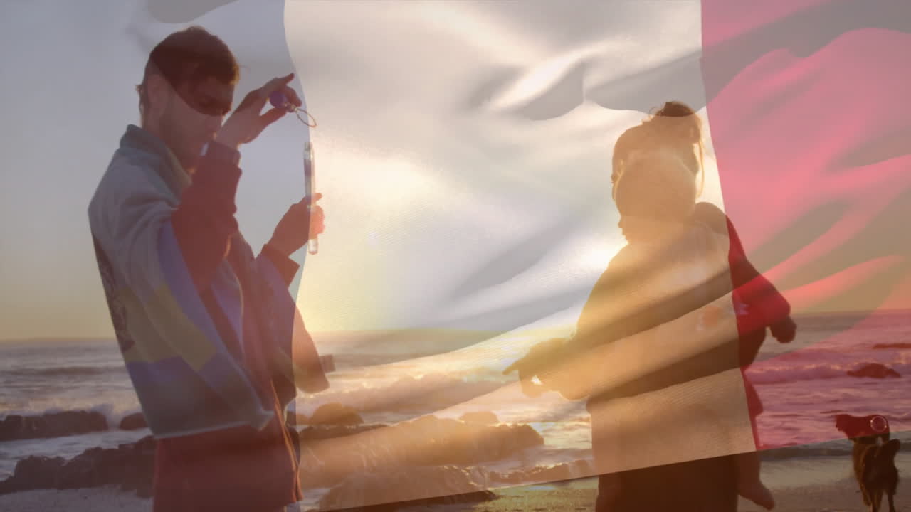 At beach, family watching sunset with waving flag in background, feeling relaxed