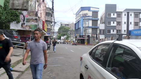 old town with passerby along the streets in cebu city, philippines, southeast asia. static shot