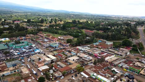 aerial view of cars and people at a open air market, in africa - reverse, drone shot