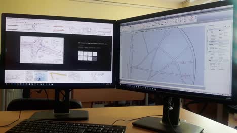 trabajando como ingeniero en la oficina con pc de doble pantalla