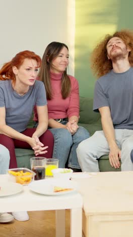 friends witnessing the end of a match, their team losing