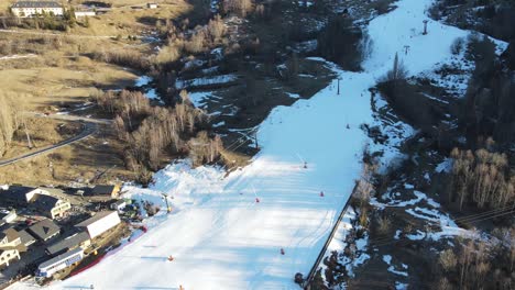 aerial drone video of people skiing slopes of a mountain in cerler ski resort, pyrenee