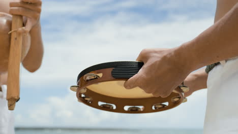 shirtless men playing musical instruments