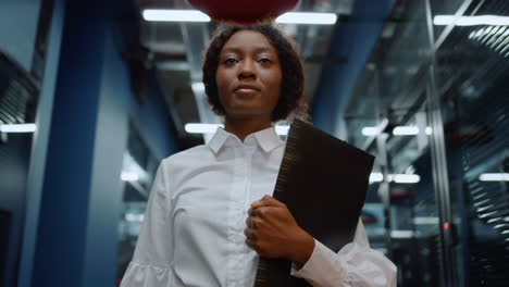 Serious-afro-woman-going-on-meeting-in-corridor.-Businesswoman-walking-on-meetup