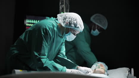 surgery in progress with medical team attending to patient