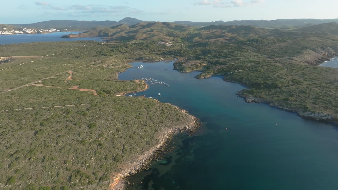Colom Island natural harbour port near Menorca Spain, aerial drone Mediterranean coastline