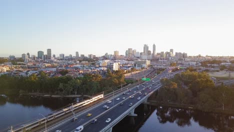 aerial sideways motion over a bridge leading to perth city in western australia