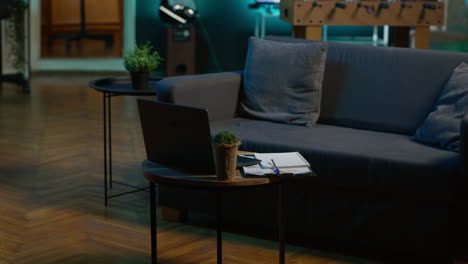 modern apartment loft with a cozy corner and trendy furniture, comfy space decorated with electronics and a coffee table. empty studio living room with minimalist decor, chill lifestyle.