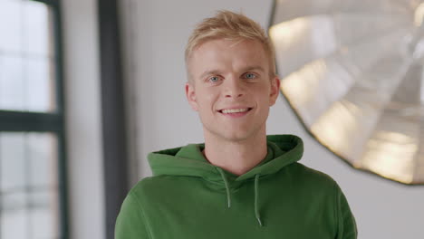 handsome blond caucasian man smiling looking straight at camera