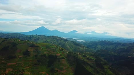 Terraced-Fields-On-The-Mountain-Hills-With-Lake-And-Volcanoes-In-The-Background-In-Uganda