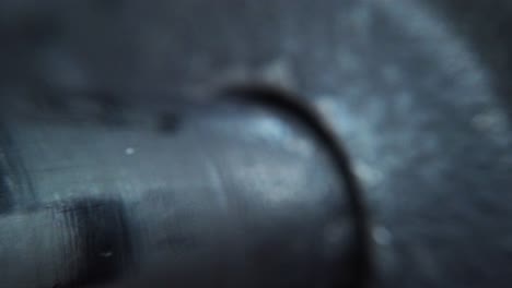 static macro shot of a male hand putting on a lock-jaw collar on a dumbbell